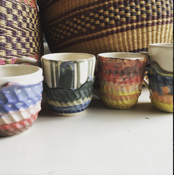 four colorful glazed mugs